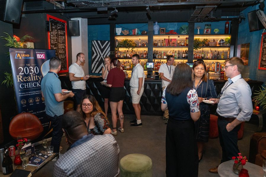 Attendees networking at the bar during the event